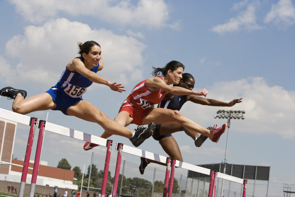 Athletes vaulting on a sunny day.