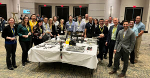 group of AO VET NA learners smiling and looking at the camera while standing around a table with VET orthopedic course supplies